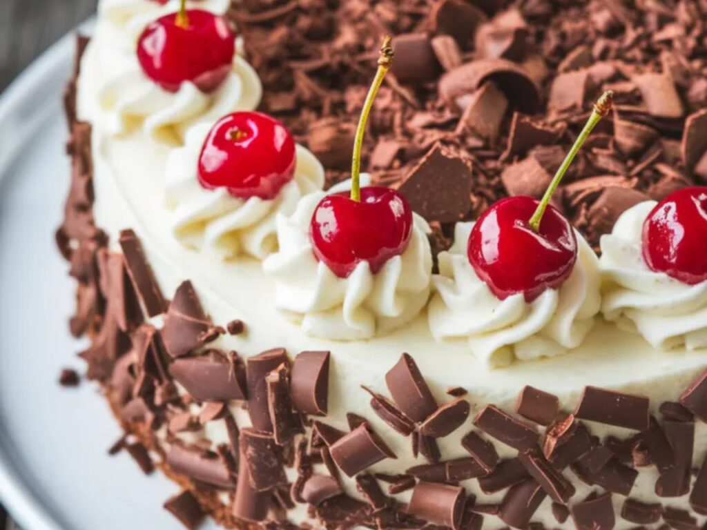 A classic chocolate and cherry cake layered with whipped cream.