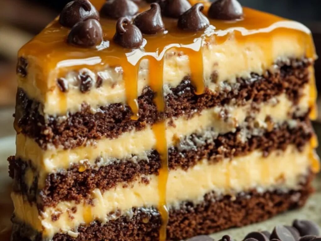 A luscious caramel chocolate chip layer cake featuring moist chocolate sponge, creamy caramel filling, and a rich caramel drizzle, topped with chocolate chips.