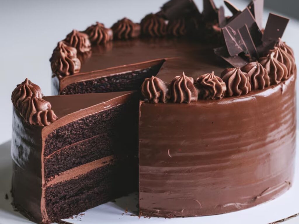 A deep, dark chocolate cake with smooth ganache and chocolate curls.