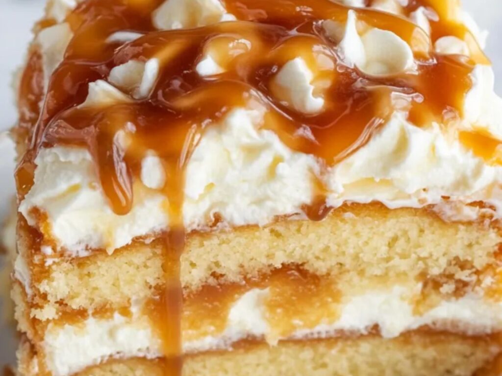 A fluffy vanilla cake soaked in salted caramel and topped with whipped cream.